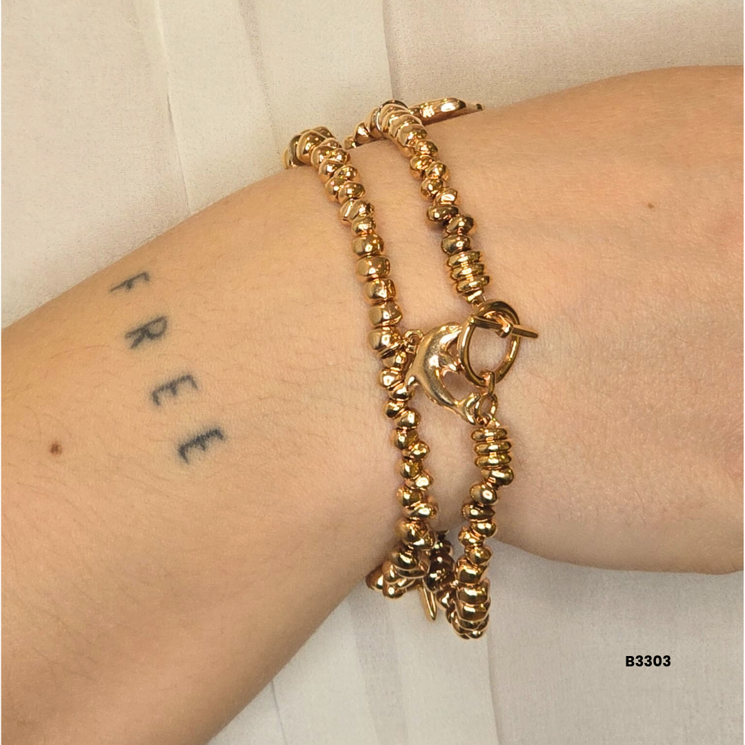 Gold bracelet with metal beads and decorative charms