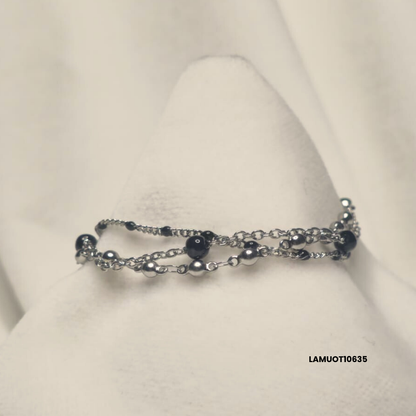 Multi-strand stainless steel bracelet with black enamel spheres